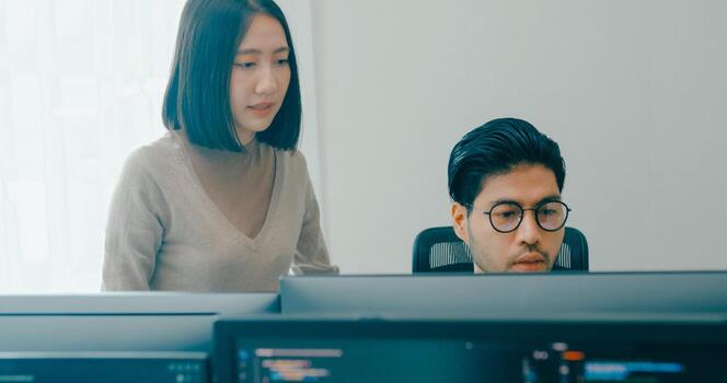 Group Asia male, female freelance meeting write prompt AI bot IT app smart program nomad, game, talk strategy, discuss plan, user interface, designer, big data center on desktop computer. photo