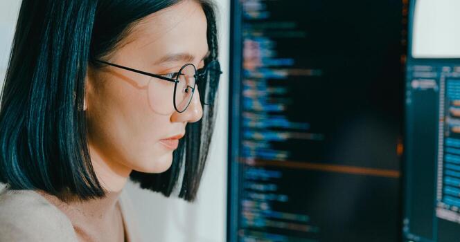 Closeup adult Asia female freelance eyeglasses typing write prompt AI bot IT app program nomad, game, terminal with coding, user interface, designer, big data center on desktop computer. photo