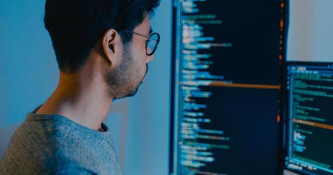 Closeup adult Asia male typing write prompt AI bot IT app smart program nomad, game, terminal with coding language, designer, big data center on desktop computer in night office. photo