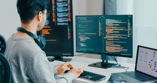 Young adult Asia male eyeglasses typing write prompt AI bot IT app smart program nomad, game, terminal with coding, user interface, designer, big data center on desktop computer. photo