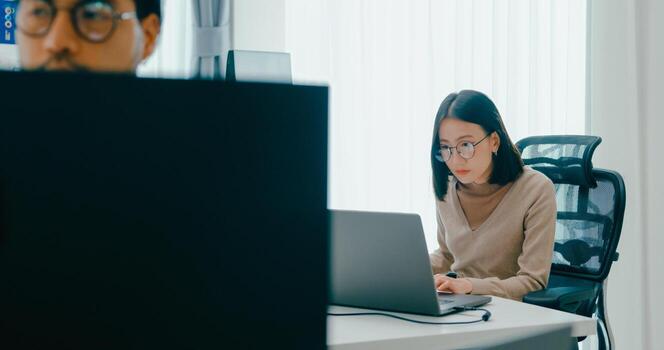 Group Adult Asia male, female freelance typing write prompt AI bot IT app smart program nomad, game, terminal with coding language, user interface, data center on desktop computer photo