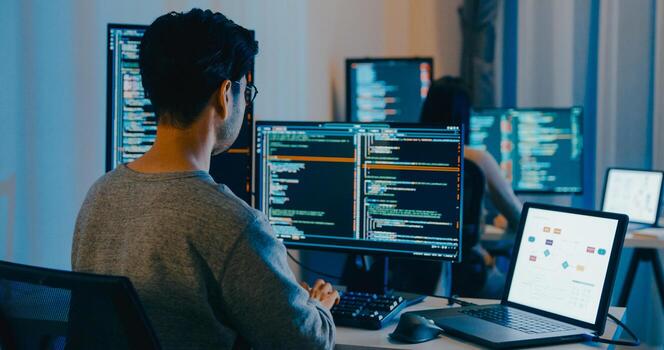 Group Asia male, female freelance typing write prompt AI bot IT app smart program nomad, game, terminal with coding language, designer, big data center on desktop computer in night office. photo