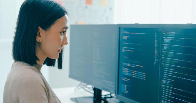 Young adult Asia female freelance typing write prompt AI bot IT app smart program nomad, game, terminal with coding language, user interface, designer, big data center on desktop computer. photo