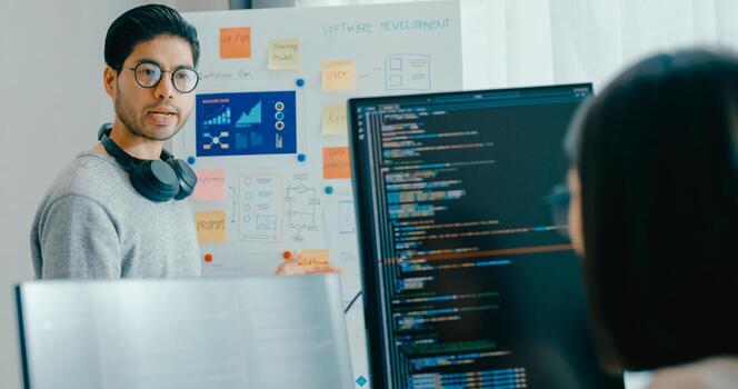 adult Asia male female software developers mentor leader manager talk strategy plan to executive write prompt AI bot IT app program nomad, game, data center. Whiteboard slideshow code photo