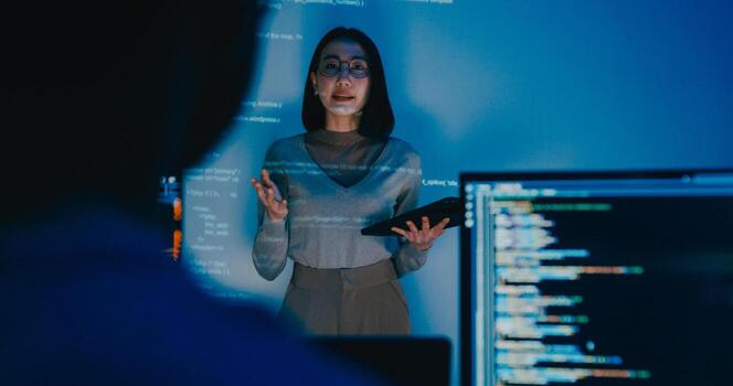 adult Asia female software developer mentor leader manager talk strategy plan to executive write prompt AI bot IT app program nomad, game, designer, data center. Projecting slideshow code. photo