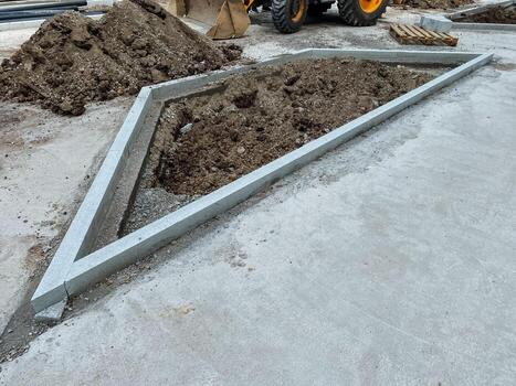 At a construction site, a powerful bulldozer is efficiently moving a large pile of dirt as an essential part of the ongoing building project that is taking place at the location photo