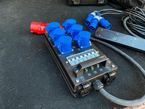 There is a black box that features a collection of blue plugs attached to it, commonly used in various electronic devices and systems for connectivity and functionality in technology photo