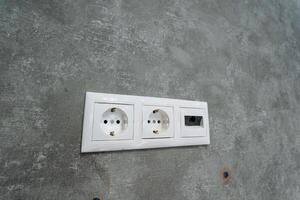 This Modern Electrical Outlet features Dual Sockets along with a convenient USB Port, elegantly installed on a sturdy Concrete Wall, perfect for enhancing your living or working space photo