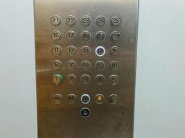 A highly polished stainless steel elevator control panel that features clearly labeled buttons corresponding to the numbers 1 through 12, providing easy access to various floors photo