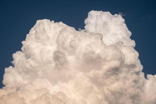 Cumulonimbus clouds appear on the sky. Cumulonimbus clouds almost always signal that there is a thunderstorm happening. photo