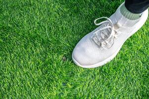 Someone standing on incomplete green artificial turf. photo