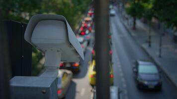 A hightech Urban Traffic Surveillance Camera positioned on a Busy Street actively monitoring video