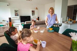 Family enjoys a cozy breakfast gathering at home today photo