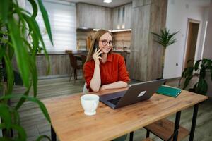 Bright and cozy indoor workspace with a woman on a call photo