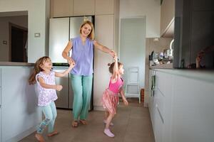 Joyful moments of children dancing in a cozy kitchen photo
