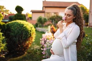 Pregnant woman in a peaceful garden with flowers photo