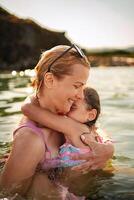 Joyful moments of family bonding at the beach during golden hour photo