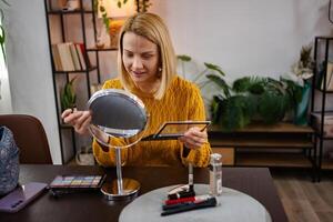 Artistry unfolds in a cozy room as a young woman prepares for her day with vibrant makeup and beauty essentials photo