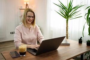 Working happily from home in a cozy environment surrounded by greenery and warm light photo