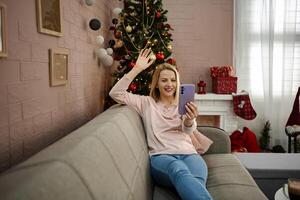 Joyful moments shared during a festive call in a cozy living room adorned for the holiday season photo