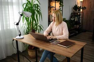 Working from home during the day brings focus and creativity in a cozy indoor workspace filled with greenery photo