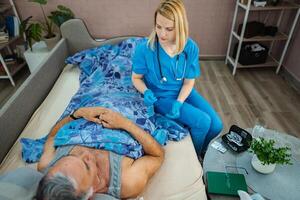 Caring nurse attends to patient in cozy bedroom setting photo