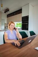 Working from home during a sunny afternoon in the kitchen photo