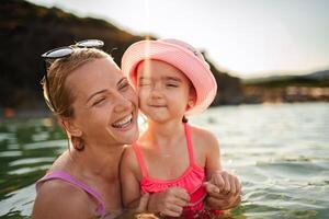 Family enjoys joyful moments together at the serene beach waters photo