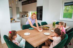 Family gathering over a delightful meal in modern kitchen photo
