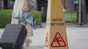 Caution sign warns of wet floor in public space video