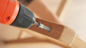 Use of electric drill for wooden furniture assembly video