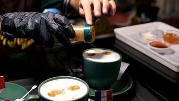 adding cinnamon in coffee. in a restaurant in the kitchen to cook video