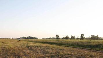 aircraft starting to take off or land on agricultural land, agriculture in motion, logistics concept, rural business, crop production video