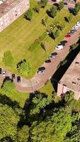 An aerial view of a large brick building with trees and grass video