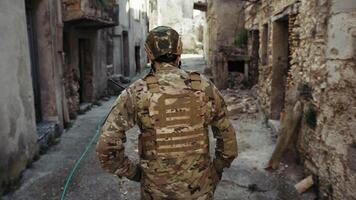 Young Soldier Walks Doing Reconnaissance In The Village Destroyed Streets video