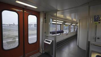 Inside the first floor of a Swiss two-level train. clean corridor, accessible toilet entrance, standing backs, large windows, and modern bright design. Efficient layout for daily travel and comfort video