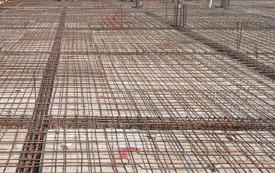 Iron fittings on wooden formwork for house floor with concrete slab photo