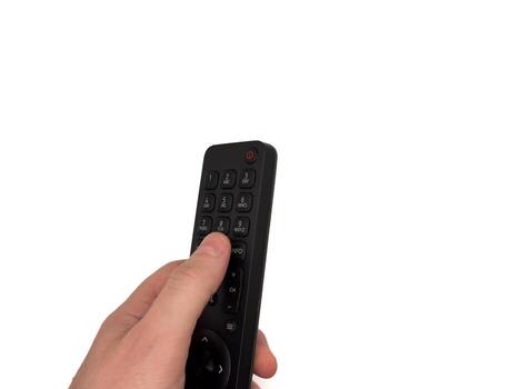 presses buttons on TV remote control man switches TV channels with remote control, for banners, for TV Copy space, flay lay, top view. photo