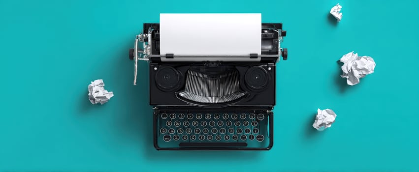 The vintage typewriter with crumpled paper on a bright turquoise background photo