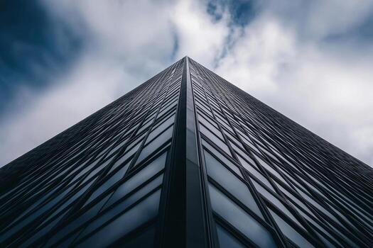 A view of a skyscraper with clouds in the background photo