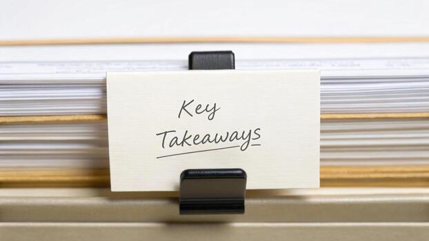 A close-up of a file folder tab labeled Key Takeaways clipped in an organized filing system. photo