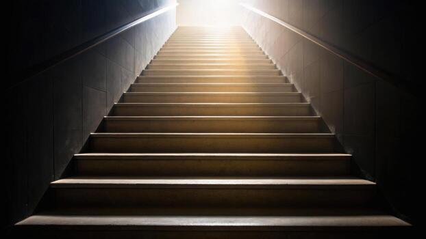 A dimly lit staircase leads upward to a bright light, symbolizing a journey from darkness to illumination or hope. photo