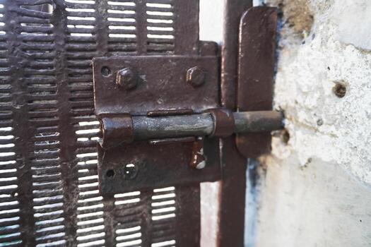 An old rusty lock. At first glance, it looks flimsy, but it is a time-tested thing that allows you to protect yourself from unauthorized entry. photo