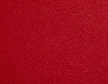 Close-up of deep crimson paper surface with a textured pattern, suitable for presentation backgrounds photo