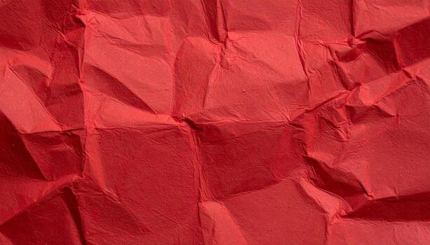 Close-up of a deep red paper surface with a textured background, ideal for presentation designs photo