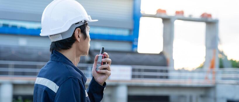 maintenance and inspector, Maintenance engineers are using walky talky to inform the results of inspection of buildings and structures. Irrigation engineers are sluice systems. photo