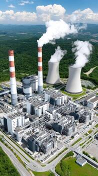 An aerial view of a power plant with smoke coming out of the chimneys photo