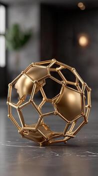 A golden ball with a metal structure on a table photo