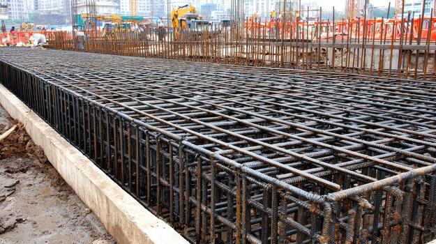 A large steel bar is being used to build a structure photo