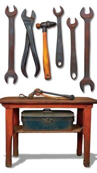 A table with wrenches, pliers, and other tools photo